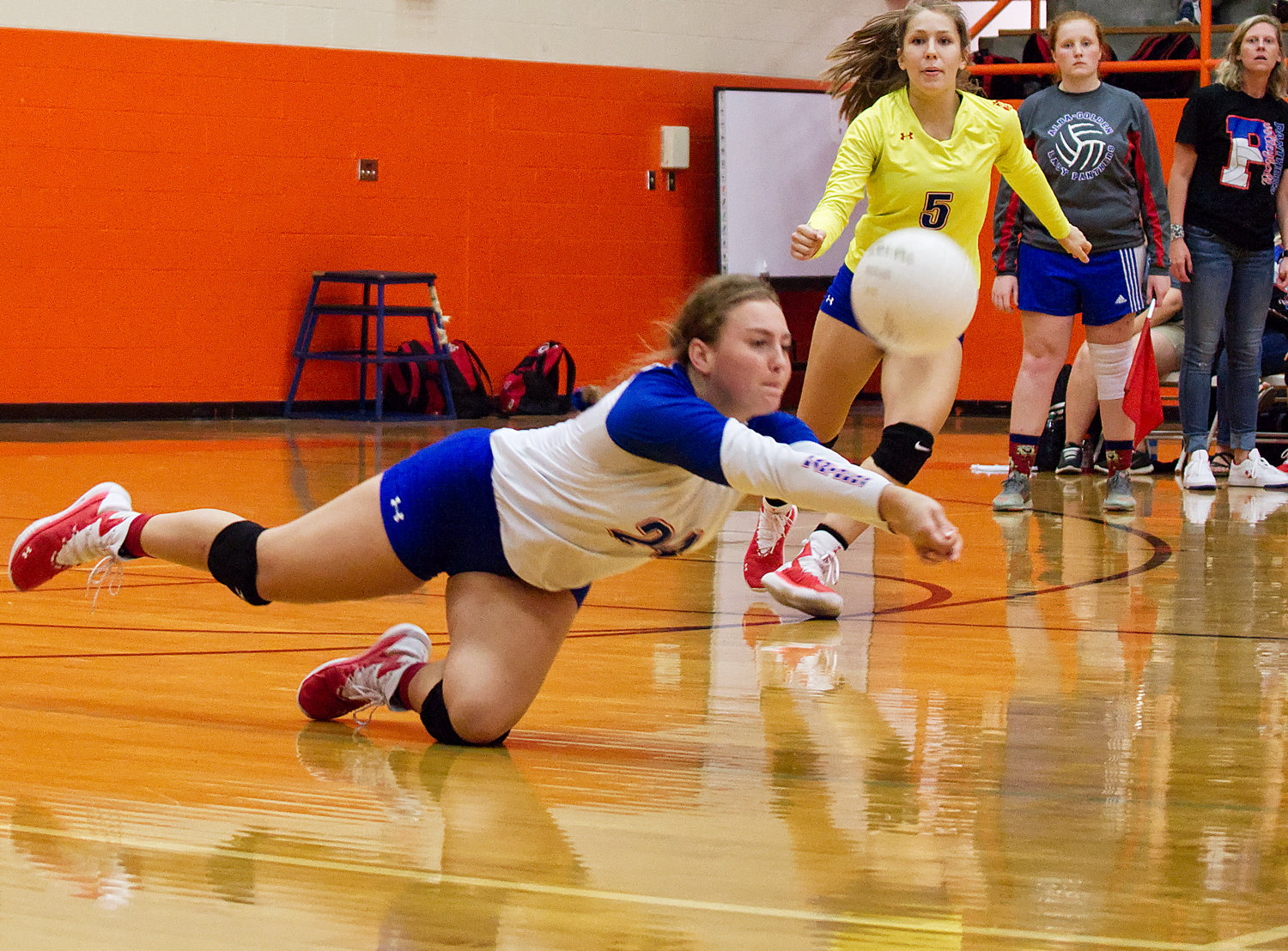 Ann Marie Pendergrass of Alba-Golden digs for a ball in district action against Mineola.